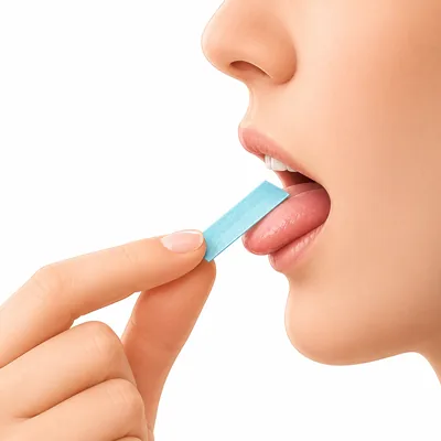 Person placing an EliteOps energy strip on their tongue